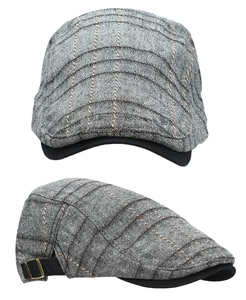 Detail view of grey plaid ivy cap showing retro metal buckle and textured fabric