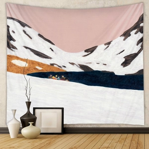 Detail of bohemian tapestry featuring snowy mountains and lake rowing scene on a wall