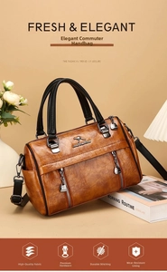 Detail of tan vintage boston bag showing lychee grain texture and kangaroo metal logo