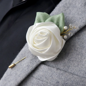 Handmade cream satin rose boutonniere with faux pearls on a grey wool suit lapel