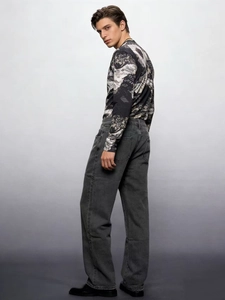 Men's relaxed fit washed denim jeans paired with landscape print long sleeve top