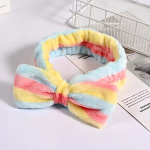 Detail of soft striped flannel headband with plush bow for facial care and skincare