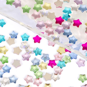 Colorful mix of star-shaped rhinestones for nail art on a bright clean white background