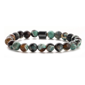 Detailed close-up of beaded bracelet with tiger eye, malachite, and volcanic stone