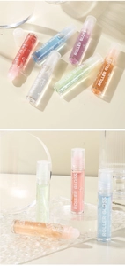 Detail view of six colorful roller lip glosses on a modern acrylic display stand