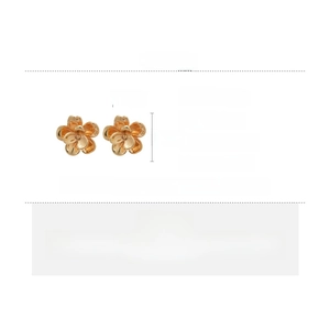 Detail view of 2.3cm golden layered flower earrings with copper material and silver pins