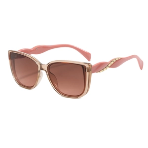 Fashionable oversized cat-eye sunglasses with wavy pink temples and brown lenses