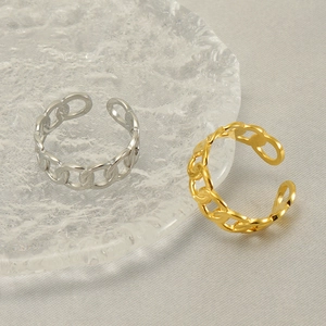 Minimalist chain link open ring in gold and silver finish on a glass plate