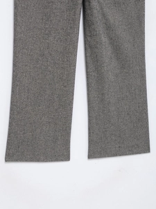 Detail showing the gray textured fabric and straight leg cut of the formal suit trousers