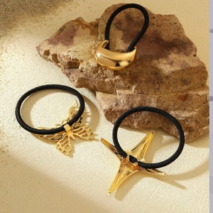 Three premium gold hair ties with crescent moon, butterfly, and star metal charms