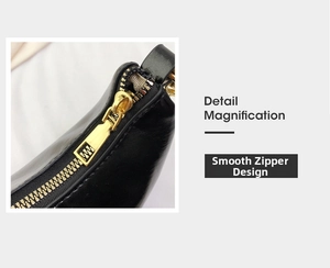 Detailed macro view of the premium golden metal zipper on a black patent leather handbag