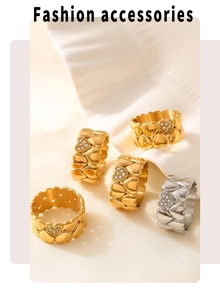 Close-up of five heart-shaped gold and silver rings with small inset diamonds