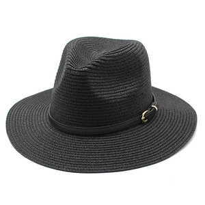 Detail of black woven straw fedora with fine texture and leather band with gold buckle