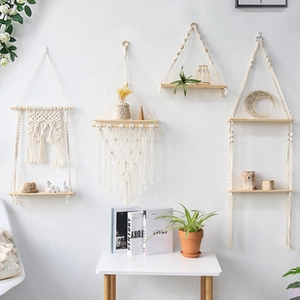 Detail view of boho macramé wall hanging shelves with beige cotton ropes and light wood