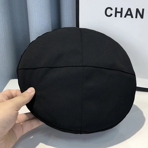 Detail of classic black beret hat showing stitched crown seams and premium cotton twill texture