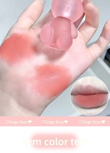 Detailed swatch of velvet matte bear lip mud in peach pink tone on arm and lips