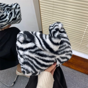 Handheld zebra print faux fur handbag with soft plush texture for stylish autumn outfits