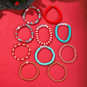 Close-up of nine colorful Christmas clay bead bracelets with Merry and Joy letter charms