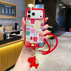 Detail of red iPhone case with God of Wealth horse charm and braided crossbody strap