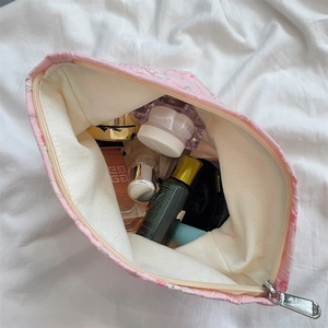 Spacious pink floral cosmetic bag with sturdy silver zipper for travel organization