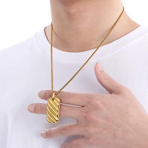 Macro shot of 18K gold plated stainless steel square pendant with wavy textured detail