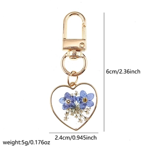 Detail of heart dried flower keychain showing 6cm height and 2.4cm width dimensions