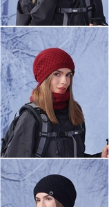 Detail of red winter knit hat with diamond pattern and fleece lining set in snowy woods