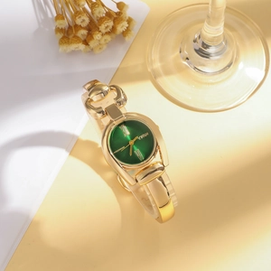 Elegante Vintage-Damenuhr in Gold mit smaragdgrünem Zifferblatt und Gliederarmband