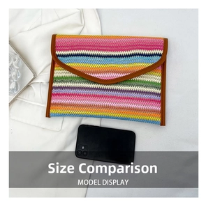 Detail of colorful striped straw clutch with phone for size comparison