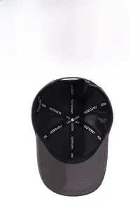 Detail view of breathable black mesh lining and logo webbing inside a gray baseball cap