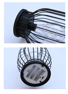 Detail view of battery compartment and LED filament bulb in iron lantern lamp