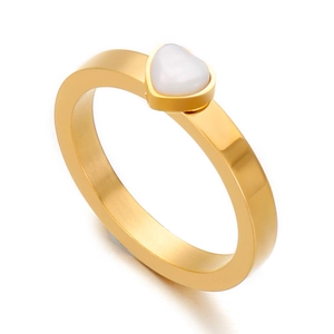 Minimalist gold heart ring with white opal inlay on a clean white background
