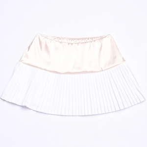 Detail view of champagne satin waist stitching on a white pleated mini skirt