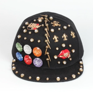 Detailed front view of punk hip hop cap with gold rivets, colorful gems and enamel charms