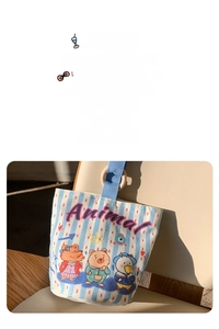 Detail of striped canvas bucket bag featuring cute animal prints and wooden ring handles