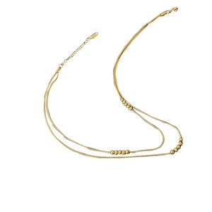 Double layered 18K gold snake chain necklace with polished beads for a minimalist look