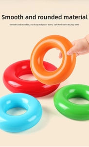 Baby hand holding a smooth orange stacking ring showing easy grip and safe rounded edges
