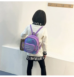 Detail view of purple sequin backpack for girls featuring a heart pocket and glitter texture