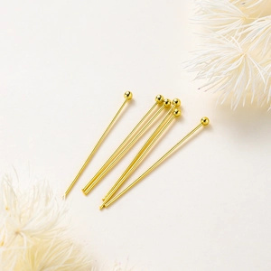 Close-up of 14K gold plated copper ball head pins for DIY jewelry making accessories