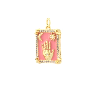 Macro detail of 18k gold plated rectangular palm evil eye pendant with pink enamel