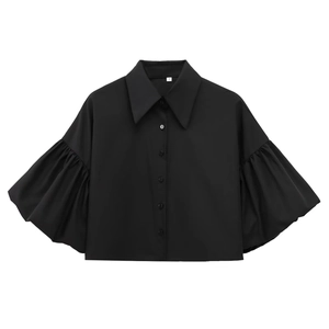 Detail of black puff sleeve shirt featuring single-breasted buttons and plain weave fabric