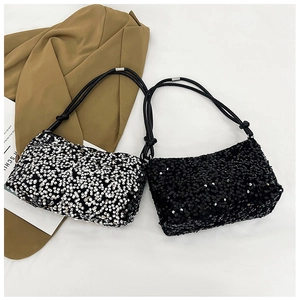 Detail of silver and black sequined baguette bags with knotted leather straps