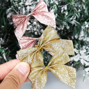 Detail of gold and pink glitter Christmas bows for tree decoration and party supplies
