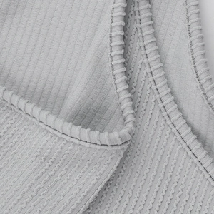 Detail of grey ribbed knit fabric showing high elasticity and fine sewing craftsmanship