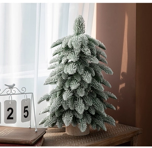 Close-up of artificial 55cm mini Christmas tree with snow-flocked PE leaves and wood base