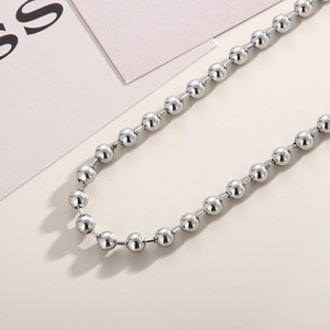 Close-up of polished silver stainless steel ball chain necklace with shiny finish