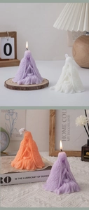 Detailed view of prayer girl candle set in purple, white, and orange wax finishes