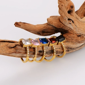 Elegant stainless steel gold rings with colorful square zircon stones on wooden branch
