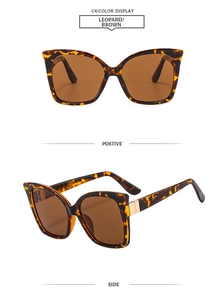 Detail view of leopard print tortoiseshell sunglasses with brown lenses and gold hardware
