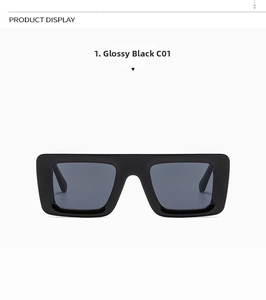 Close-up of rectangular black sunglasses with glossy frames and dark grey lenses